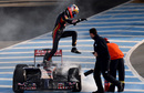 Jean-Eric Vergne jumps from his smoking Toro Rosso 