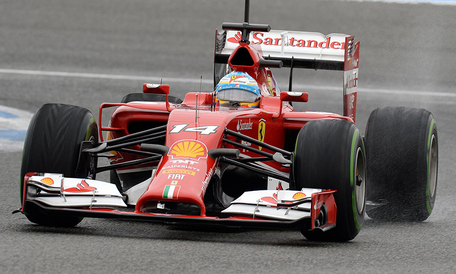 Fernando Alonso drives through the wet