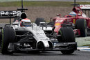 McLaren's Kevin Magnussen leads Fernando Alonso through the chicane