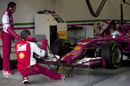 Ferrari mechanics prepare Fernando Alonso's car to hit the track