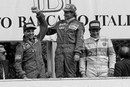 Race-winner Niki Lauda raises the hand of Ferrari's Michele Alboreto, who finished second 