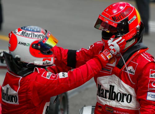 Rubens Barrichello congratulates team-mate Michael Schumacher for winning the 2003 San Marino Grand Prix 