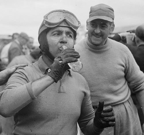 Alberto Ascari quenches his thirst after wining the British Grand Prix