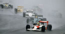 Ayrton Senna, the eventual winner, leads in the rain at Copse Corner