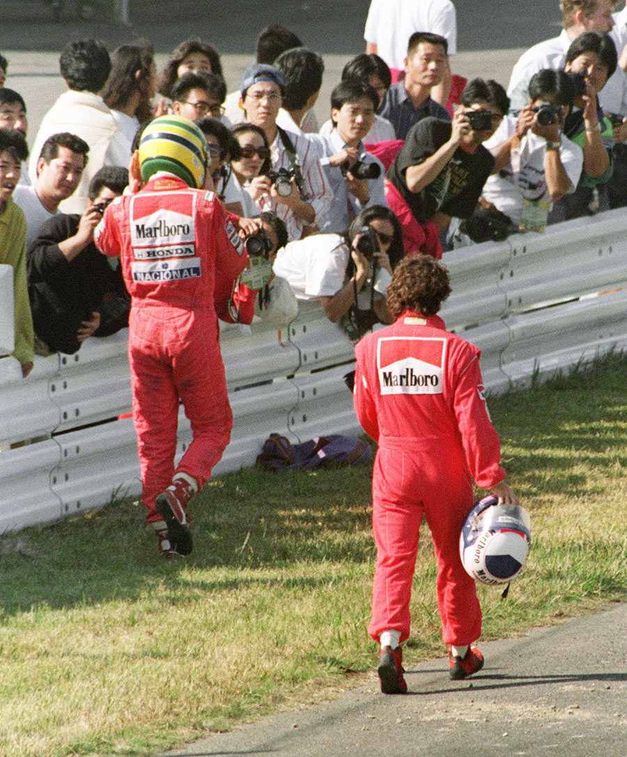 Ayrton Senna and  Alain Prost head back to the pits after their collision