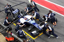 Rubens Barrichello's car is serviced by the Williams pit crew