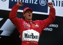 Michael Schumacher takes his customary leap after winning the San Marino Grand Prix