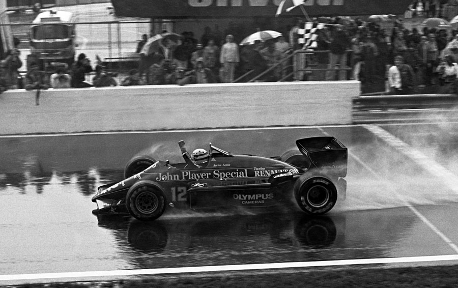 Ayrton Senna crosses the line in the damp for his maiden Grand Prix win