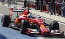 Fernando Alonso drives down the pit lane 