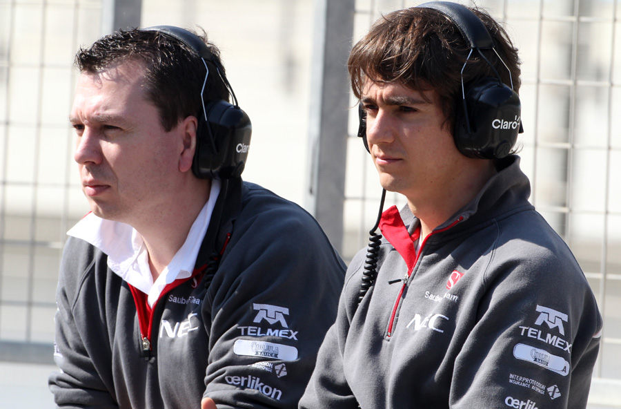 Sauber's Esteban Gutierrez (right) watches proceedings from the pit lane