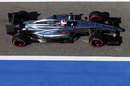 Jenson Button drives down the pit lane