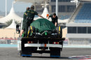 The Caterham returns to the pits on a flatbed after stopping on track