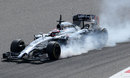 Kevin Magnussen locks up heavily in the MP4-29