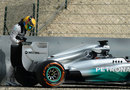 Lewis Hamilton inspects his Mercedes after it stopped on track