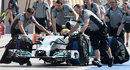 Lewis Hamilton is wheeled down the pit lane