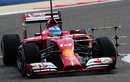 Fernando Alonso enters a corner with aero sensors on his Ferrari