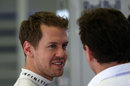 Sebastian Vettel talks with Red Bull boss Christian Horner in the garage