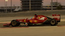 A side view of Fernando Alonso as he laps under the lights