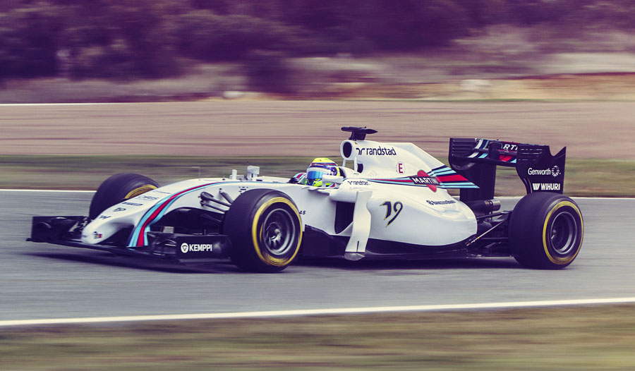 A side on view of the Felipe Massa behind the wheel of the Williams FW36, with its new Martini livery