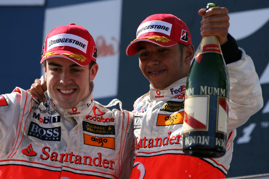 Fernando Alonso and Lewis Hamilton celebrate second and third on the podium