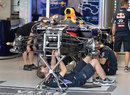 Mechanics work on the Red Bull RB10 in full view of photographers