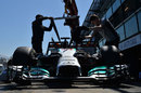 Lewis Hamilton's Mercedes is recovered to the pit lane 
