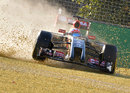 Romain Grosjean slides through the gravel after a suspected suspension failure