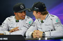 Lewis Hamilton and Nico Rosberg talk between themselves in the press conference