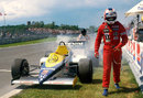 Nigel Mansell walks from his smoking Williams car
