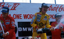Keke Rosberg celebrates victory alongside Ferrari duo Stefan Johansson and Michele Alboreto