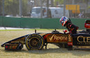 Romain Grosjean clambers out of his car after spinning into the gravel