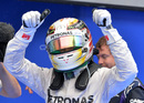 Lewis Hamilton gestures to the crowd after equalling Jim Clark's pole record