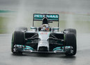 Lewis Hamilton enters a corner in the wet during qualifying