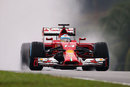 Fernando Alonso drives through the spray in qualifying