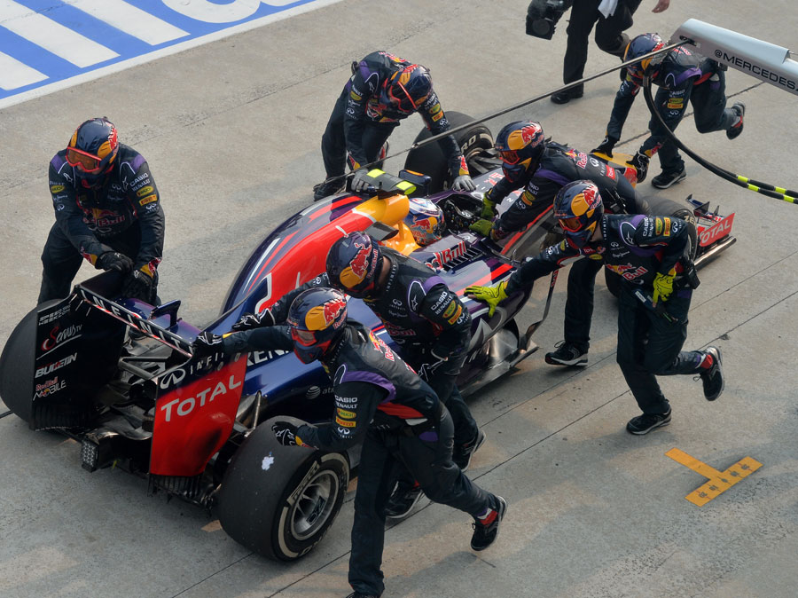 Daniel Ricciardo's pit crew scramble him back to their slot after his botched pit stop