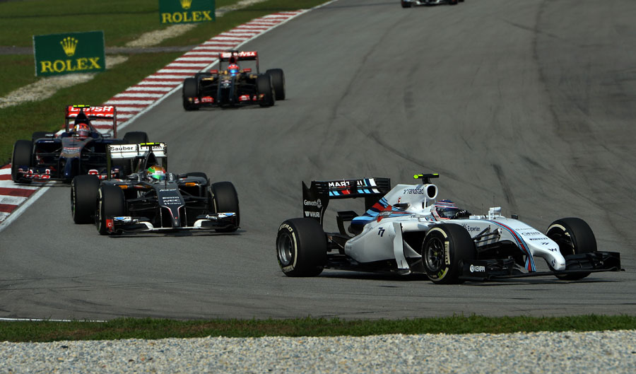 Felipe Massa leads a train of cars 