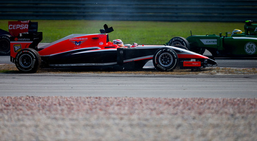 Jules Bianchi ends up backwards in the gravel after making contact with Pastor Maldonado
