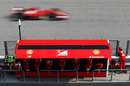 Fernando Alonso passes the Ferrari pit wall
