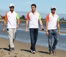 Out in force: Tonio Liuzzi,  Paul di Resta and Adrian Sutil stroll along the beach
