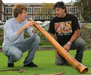 Sebastian Vettel is given lessons on how to play a didgeridoo