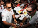 Lewis Hamilton signs autographs for the fans
