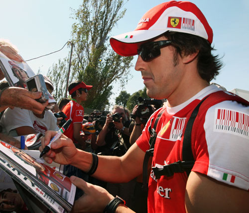 Fernando Alonso signs programmes for F1 fans