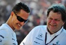 Michael Schumacher shares a joke with Norbert Haug in the Albert Park Paddock