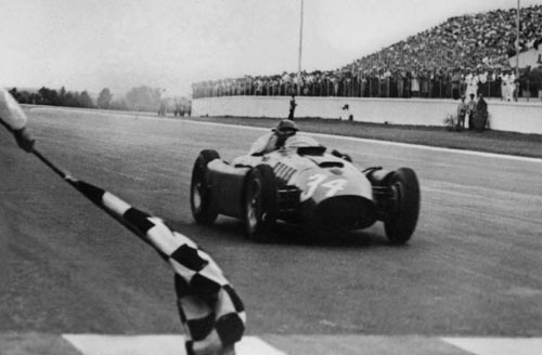 Juan Manuel Fangio crosses the line to win the Argentinean Grand Prix