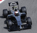 Kevin Magnussen turns in to a corner
