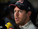 Sebastian Vettel talks to the media after failing to make Q3