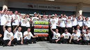 Jenson Button with team-mate Kevin Magnussen and the McLaren team ahead of his 250 grand prix start
