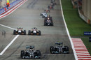 Lewis Hamilton defends from Nico Rosberg as the Force Indias duel after the restart