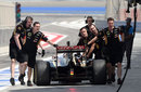 Lotus mechanics wheel Romain Grosjean back to the garage