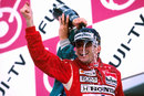 Ayrton Senna celebrates on the podium